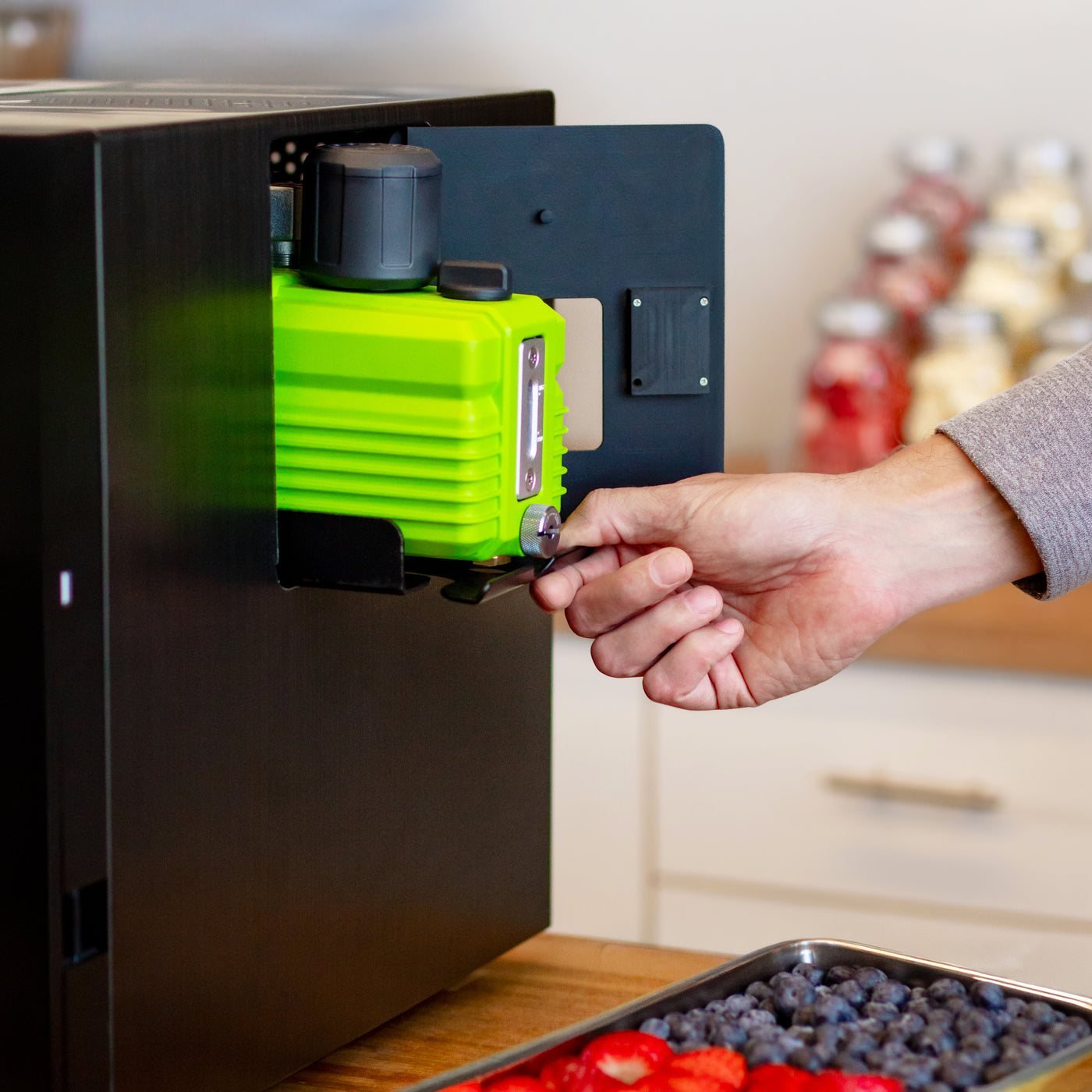 Opening the side compartment of the Countertop 360 to reach the built-in vacuum pump